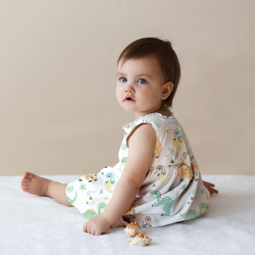 Popeline de coton blanche peigné motif bébé dino