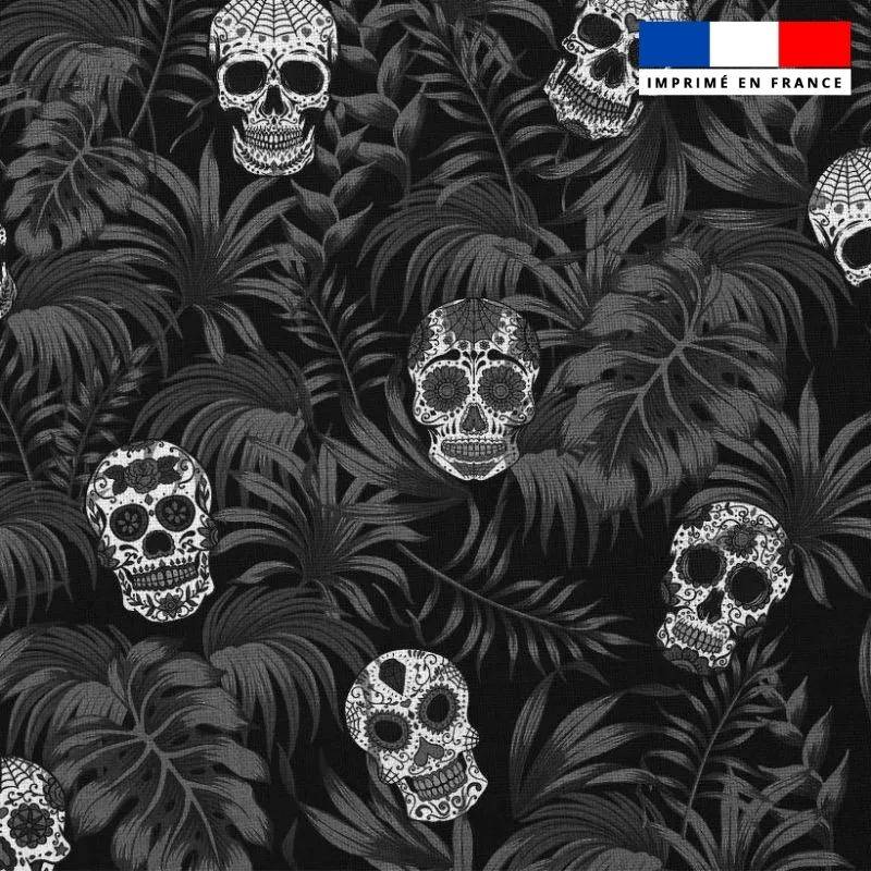 Popeline de coton peigné noire motif jungle tête de mort blanche